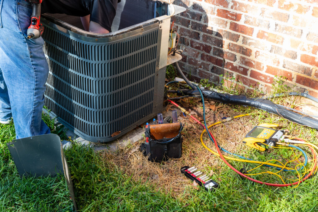 A tech working inside a condenser